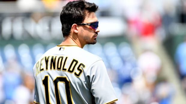 Pirates center fielder Bryan Reynolds takes off his helmet in between innings during a game.